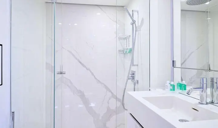 Bathroom aboard yacht Genny, visible sink and tiled shower enclosure