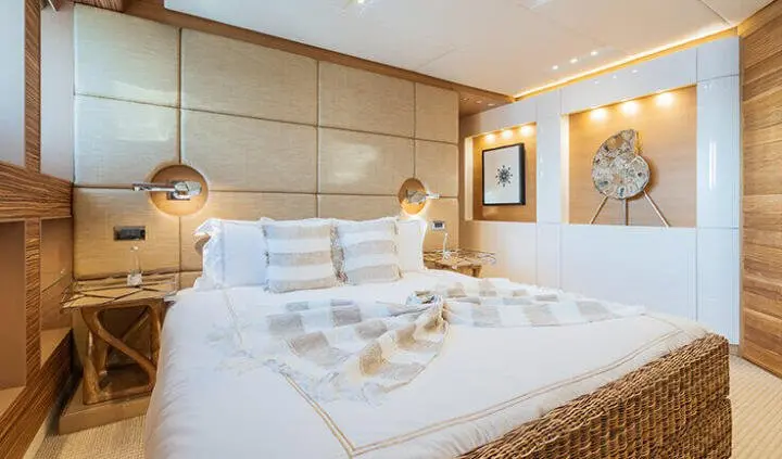 Serenity cabin with a neatly made bed, white linens, and warm lighting