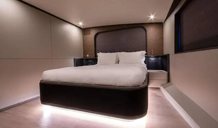 Double cabin with two queen beds on Good Life yacht, soft lighting