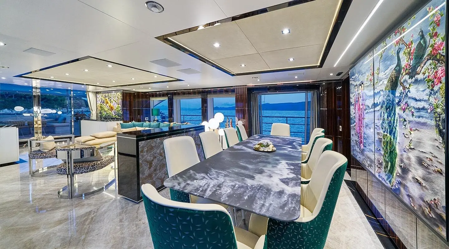 Interior of Happy Me motor yacht saloon with dining table and seating