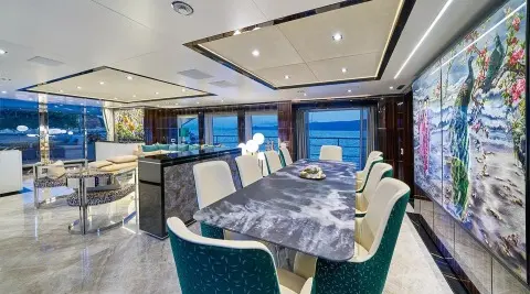 Interior of Happy Me motor yacht saloon with dining table and seating