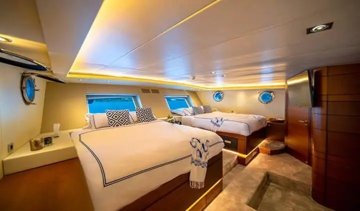Double Eagle cabin ensuite aboard yacht with bed and seating area