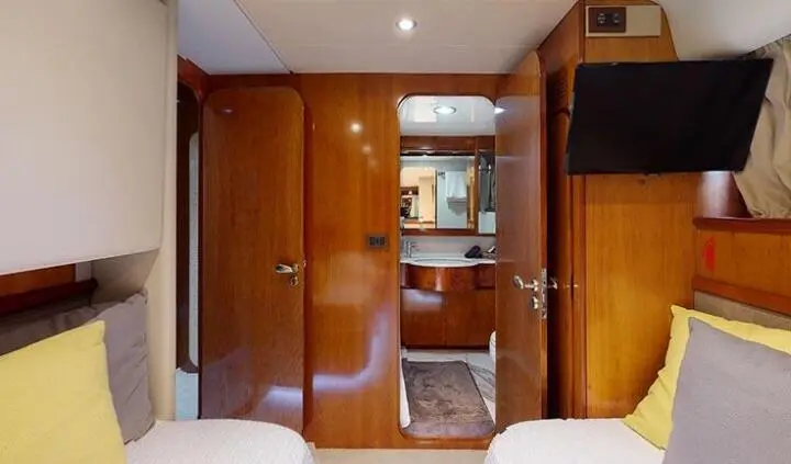 Twin cabin with bathroom aboard Lady Natassa yacht, visible wood interior