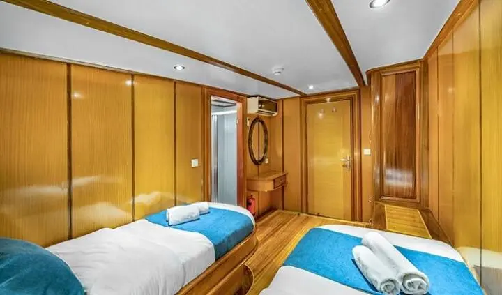 Twin single cabin aboard Tersane 8 yacht with wood interiors and porthole