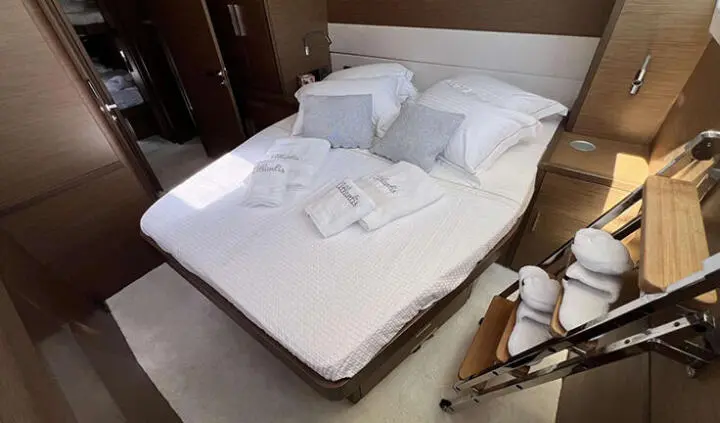 Atlantis cabin with a large bed, white linens, and two pillows