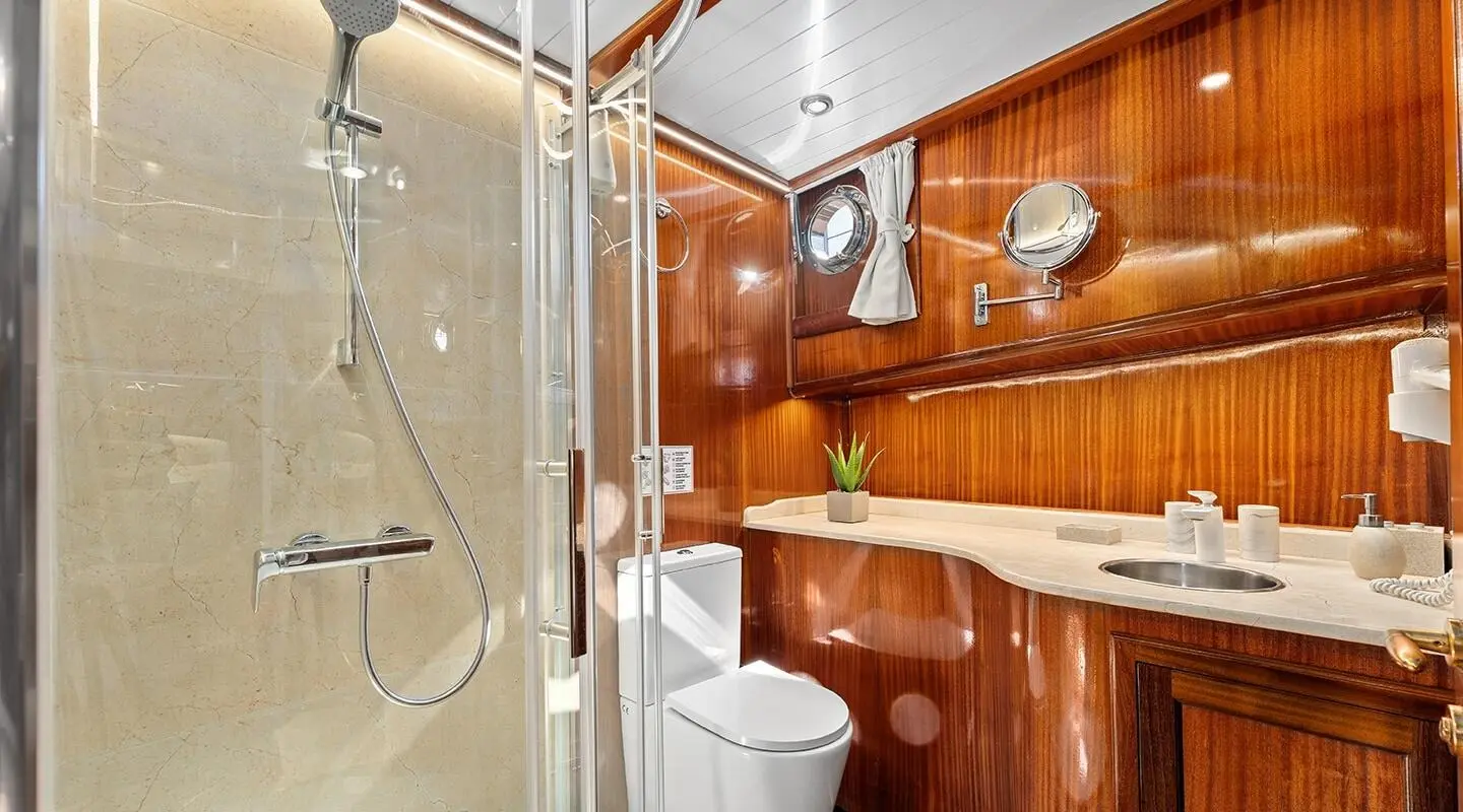 Luxurious yacht Smart Spirit interior with polished wooden panels and bathroom