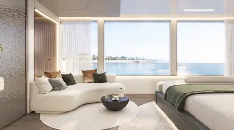 Interior view of a yacht living area with large windows overlooking the sea