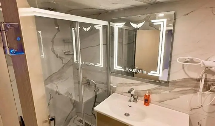Angelo III cabin ensuite aboard a yacht with mirrored vanity and sink
