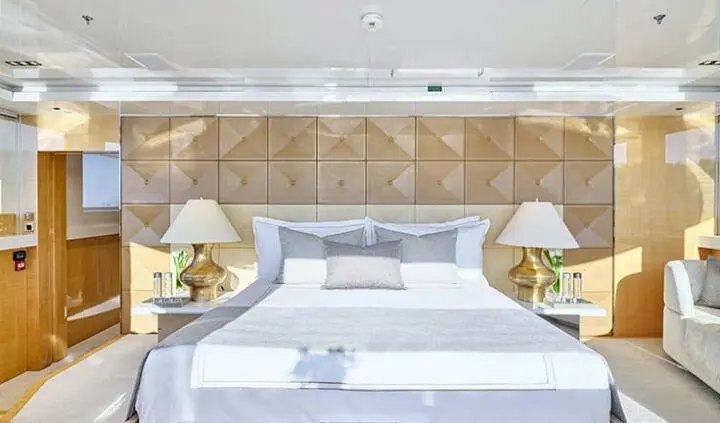 La Pellegrina 1 cabin with a large bed, headboard, and bedside lamps