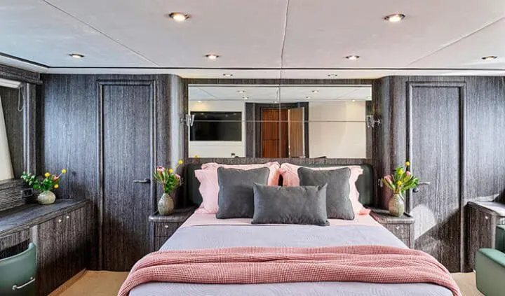 Master cabin with king bed, ensuite, blue and gray accents, soft lighting