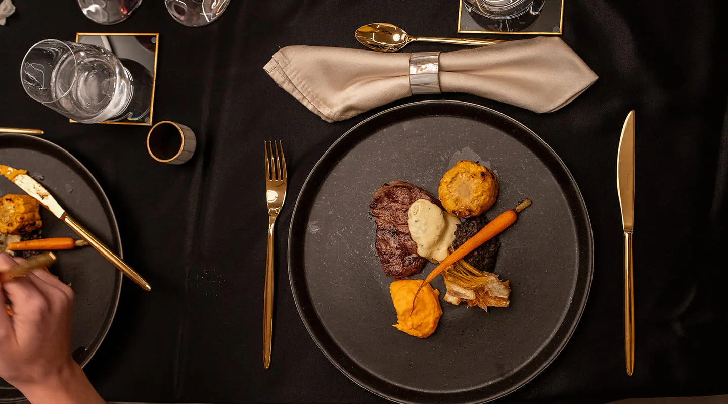 Nocturno yacht deck table setting with plate, bread, and napkin