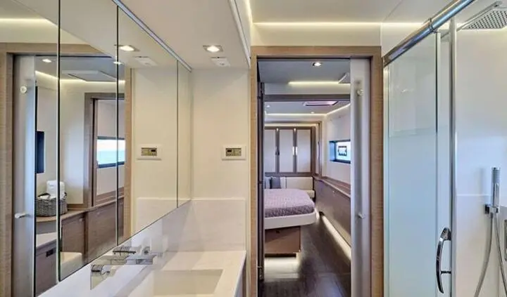Master cabin with king bed, ensuite, neutral tones, doorway to corridor