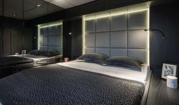 Alteya master cabin with king bed and plush headboard, ensuite visible