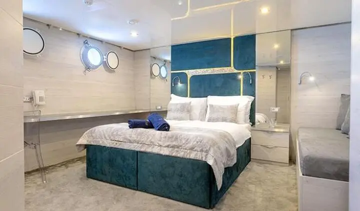 Master cabin with king bed, ensuite, porthole windows, modern decor