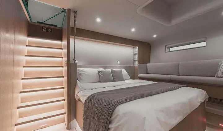 Master cabin aboard Nadamas with king bed, ensuite, cool grey tones