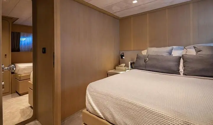 Cozy master cabin with a large bed and wooden wall paneling