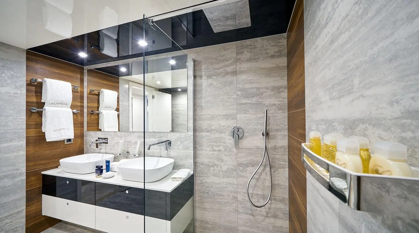 Yacht Acapella bathroom with glass shower, modern tiles, and sink area
