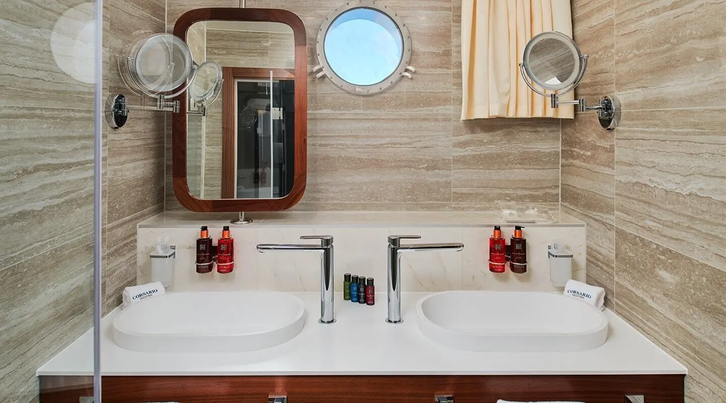 Luxurious yacht bathroom double sinks with mirrors and wooden cabinetry