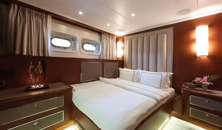 Ocean Breeze master cabin with king bed, ensuite, wood paneling and built-in storage
