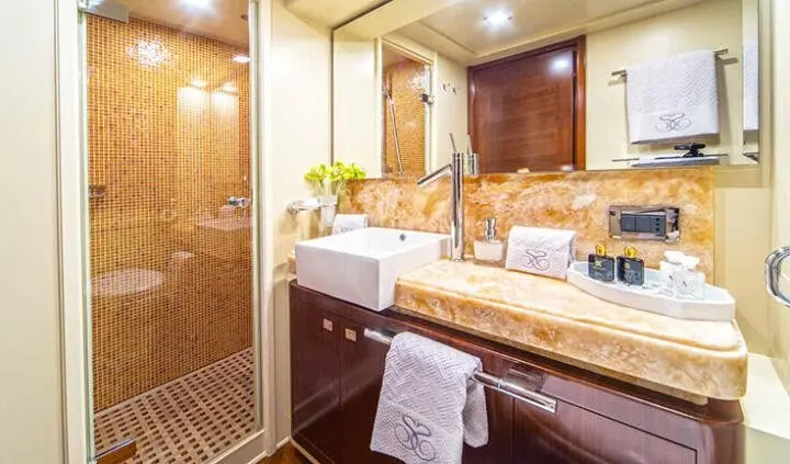 Bathroom aboard Seventh Sense yacht cabin with wooden accents and mirror