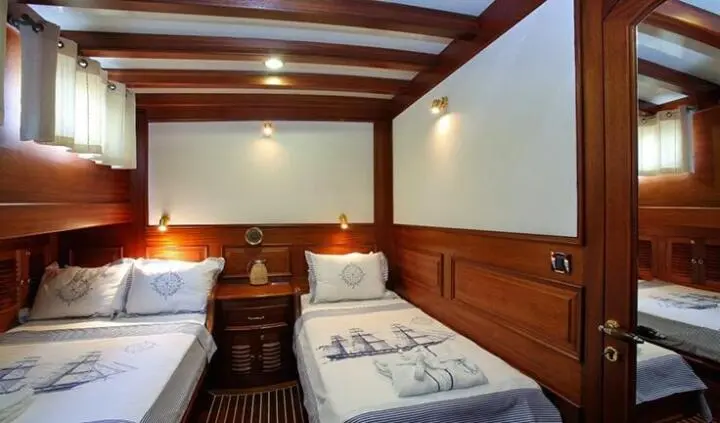 Twin cabin interior on Kaya Guneri 4 yacht with wooden walls and two single beds