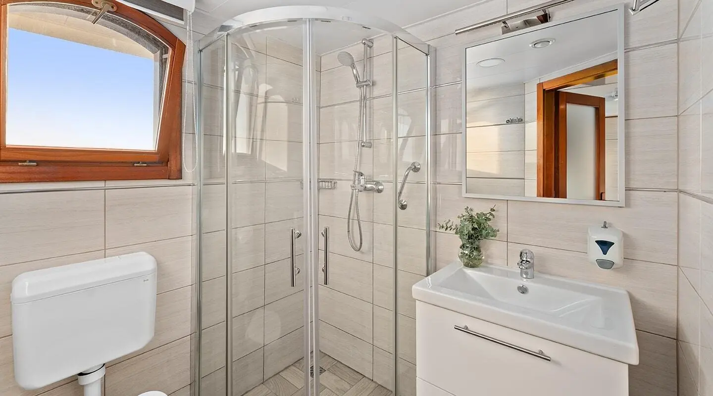 Karizma yacht exterior interior view with glass shower enclosure and sink