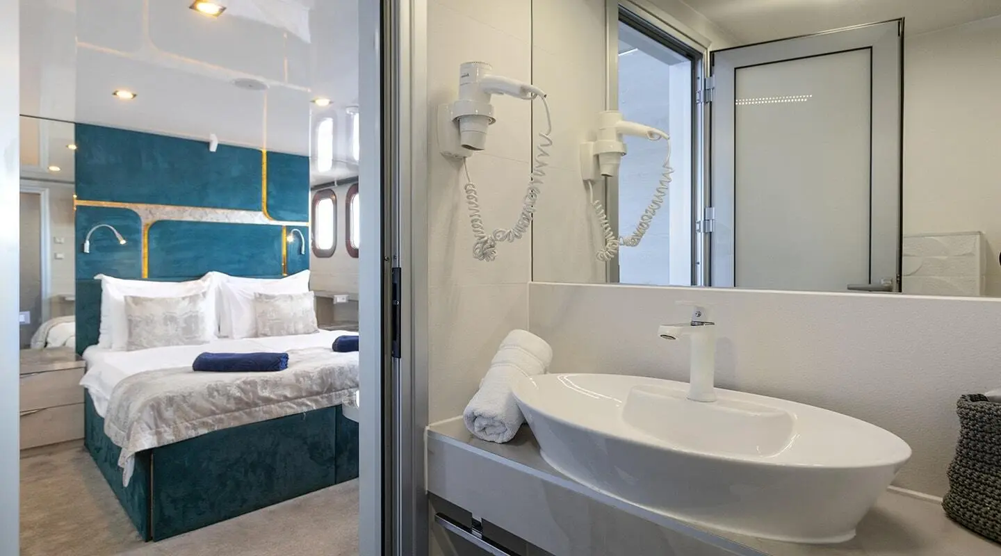 Yacht Yolo bathroom interior with sink, mirror, and shower area visible