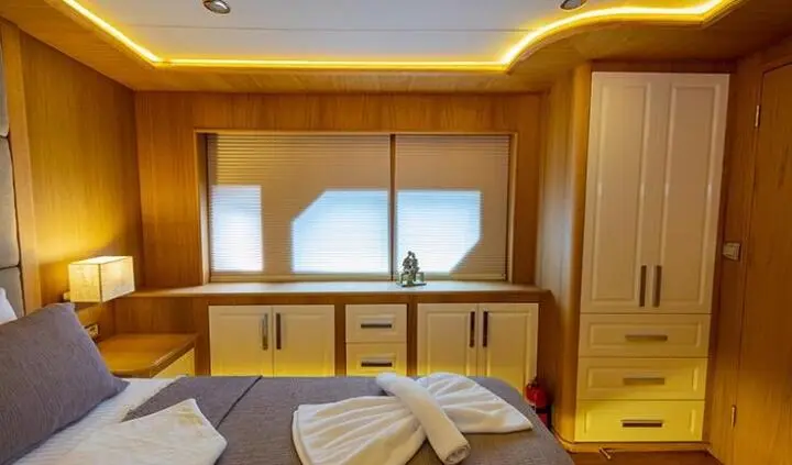 Master cabin with king bed, wooden panels, large window, ensuite hints