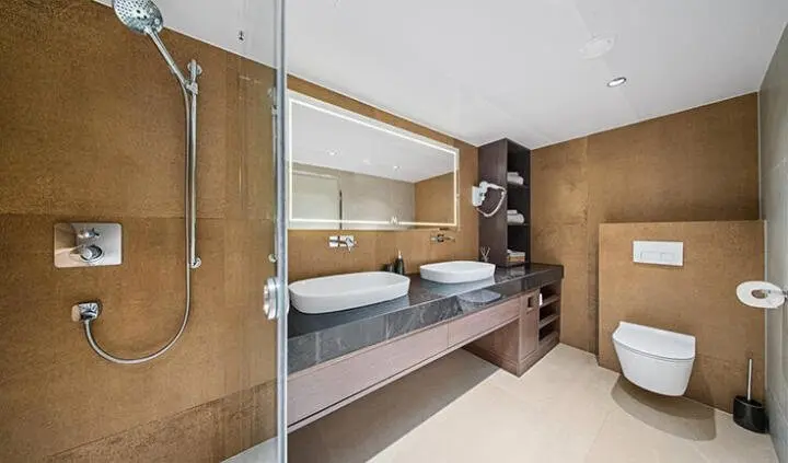 Anima Maris cabin interior with white and wood tones, double bed and storage