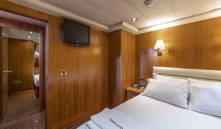Double cabin on Queen Of Sea yacht with two single beds and wood paneling