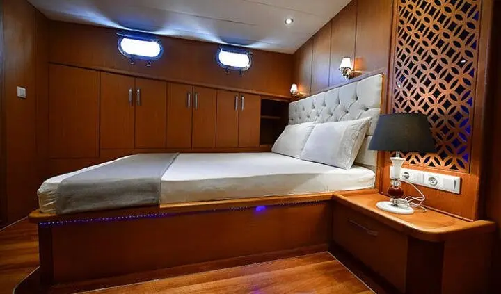 Blu Dream cabin with a king bed, wooden cabinetry, and bedside lamps