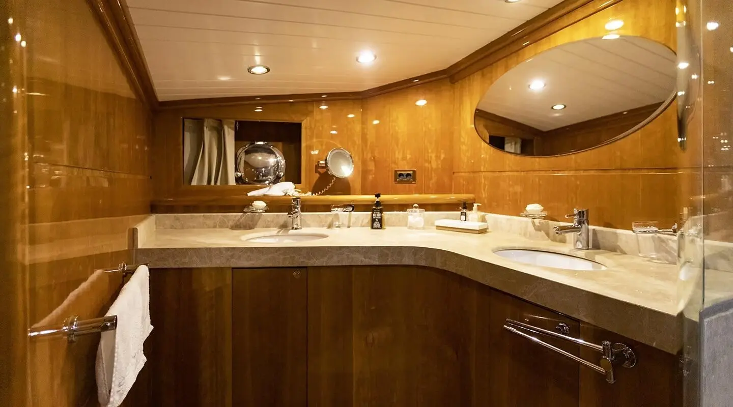 Silver Moon yacht kitchen area with wooden cabinets and curved counter
