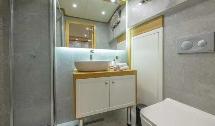 Cabin ensuite bathroom on Belgin Sultan yacht, compact vanity and mirror