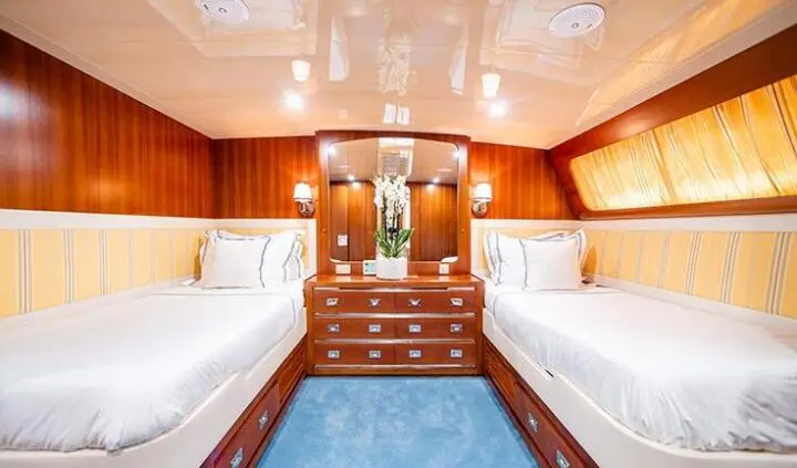 Twin cabin with ensuite beds on Wind Of Fortune yacht, wood paneling