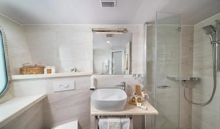 Olimp yacht master cabin with king bed, ensuite bathroom visible