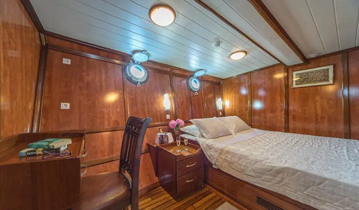 Luna yacht master cabin with king bed, wood paneling, ensuite hints visible