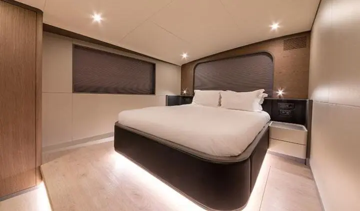 Master cabin with a large bed, two nightstands, and ensuite bathroom door visible