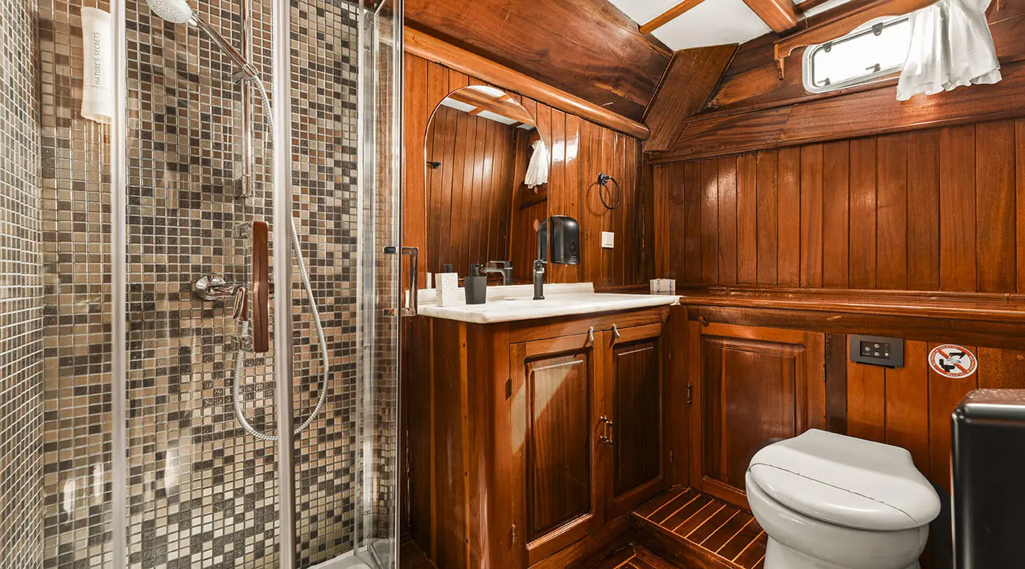 Luxury galley of a yacht with wooden cabinets and marble-pattern wall panels