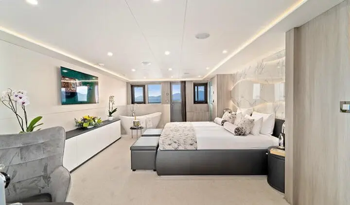 Master cabin with king bed, ensuite, bright windows, soft gray decor