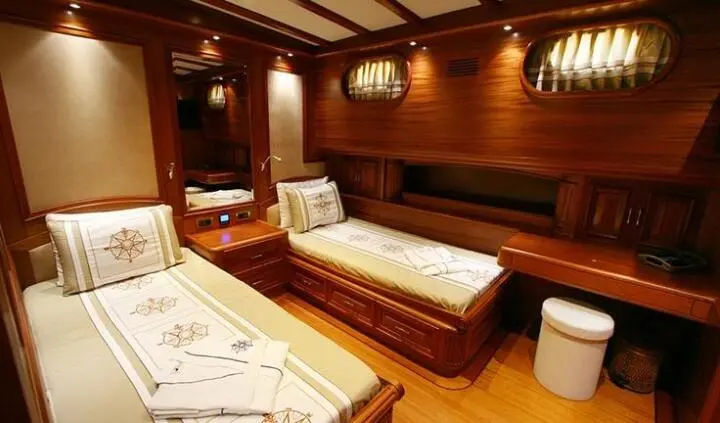 Twin cabin interior on Kaya Guneri 5 yacht with wooden walls and beds
