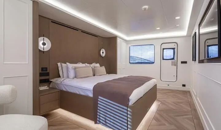 Illusion II cabin with king bed, white bedding, wood accents, ensuite door visible
