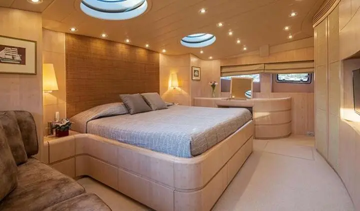 Glaros master cabin with king bed and ensuite bathroom visible in yacht interior