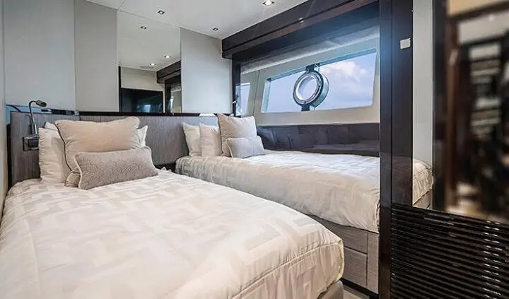 Twin cabin with two queen beds and large window seating area aboard Quantum