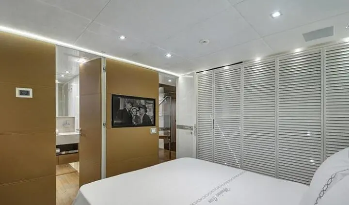 Morning Star cabin interior with bed, wall TV, lighting, and patterned wall accents