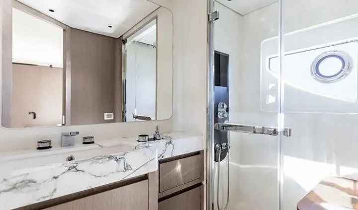 Viva II cabin interior with marble vanity, large mirror, and glass enclosed shower
