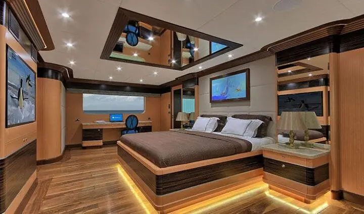 Meira yacht master cabin with king bed, ensuite, warm lighting, wood accents