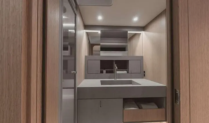 Nadamas yacht cabin interior with modern vanity, sink, mirror, and polished wood accents