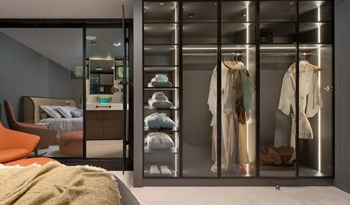 Anetta yacht cabin with a large king bed, ensuite, and dark wood accents