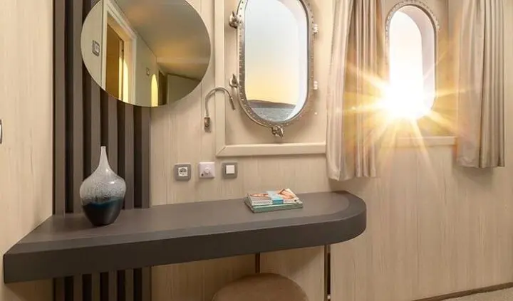 Elegant yacht master cabin with king bed, ensuite and modern wood contrasts