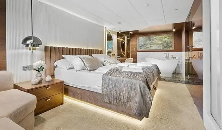 Bella yacht master cabin with king bed, plush headboard, and ensuite door